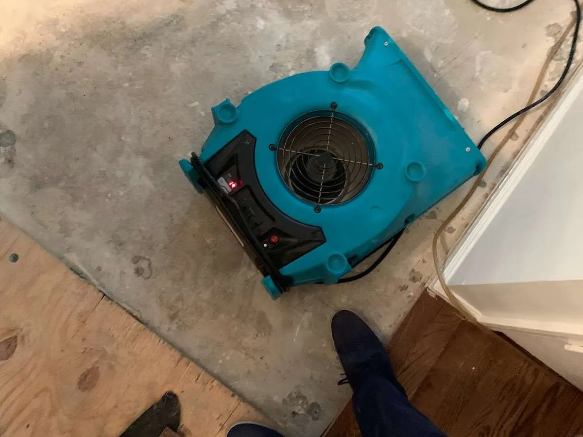 Air mover drying subfloor during Commercial Water Damage Restoration in Sandwich
